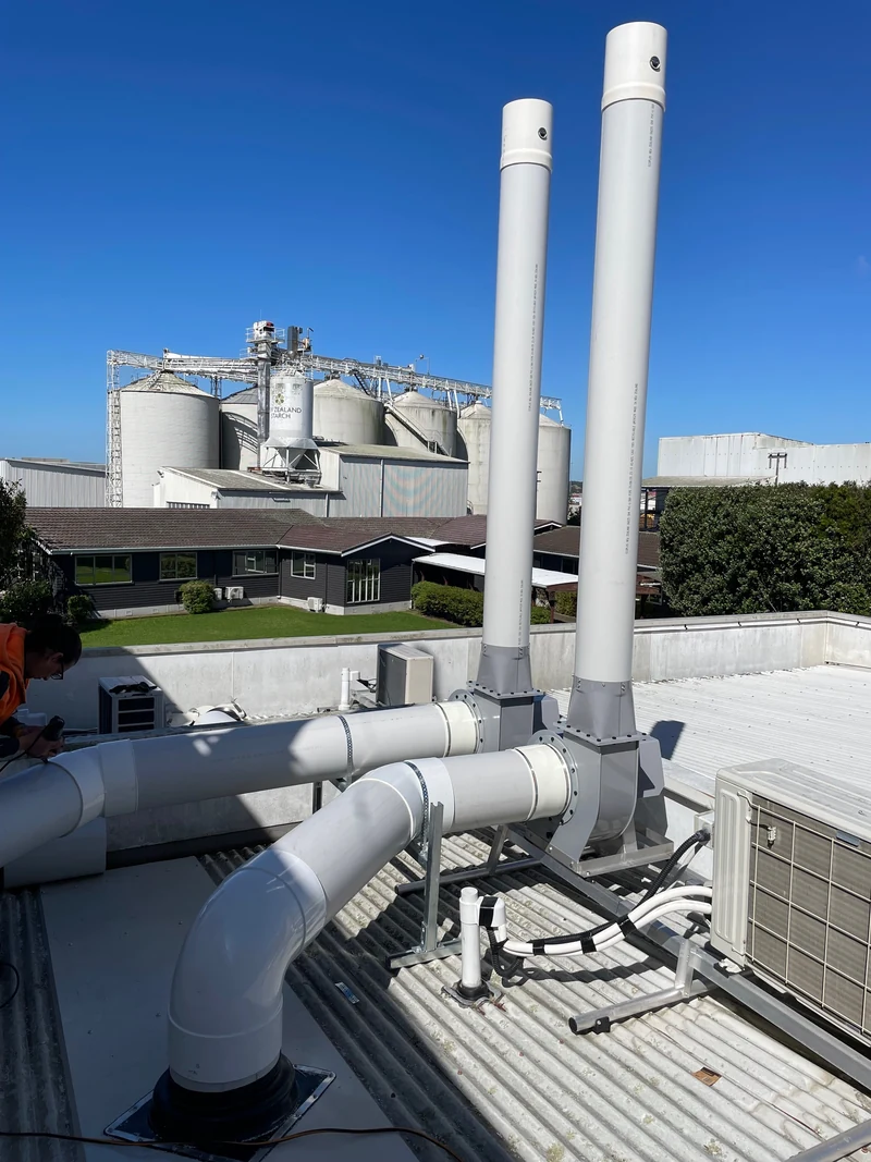 Extraction discharge stacks above a building roof
