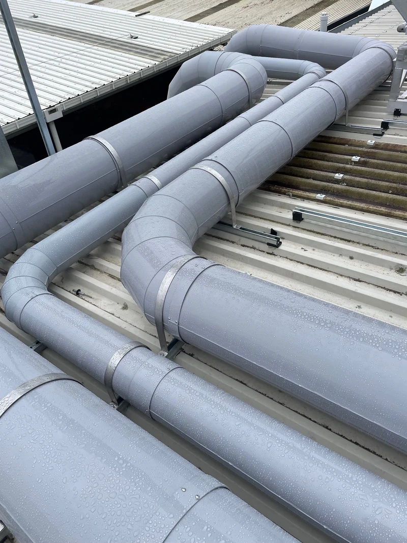 PVC extraction ductwork installed on a roof